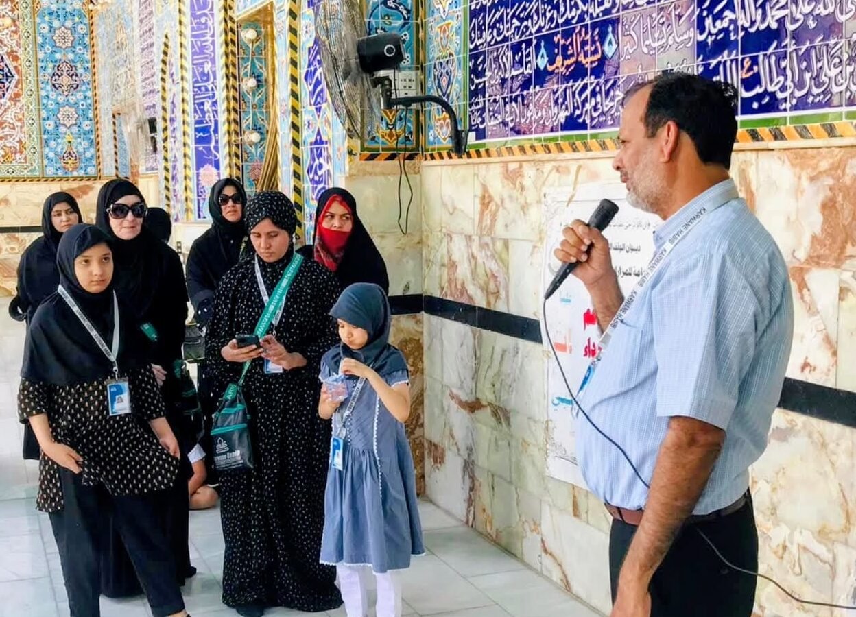 Group coordinator guiding Zaireen in the shrine courtyard