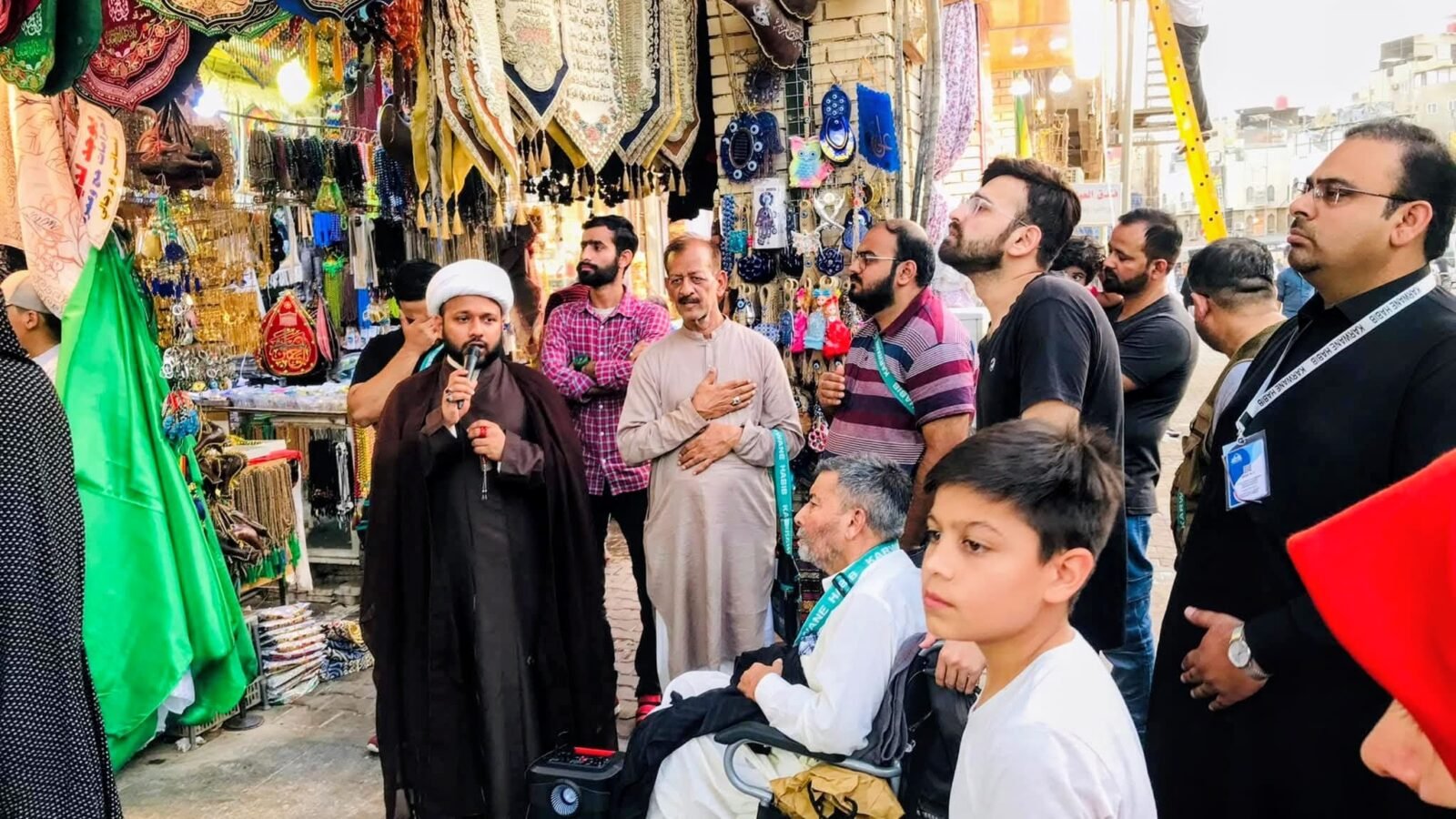 Group guide briefing Zaireen in the bazaar beside the shrine