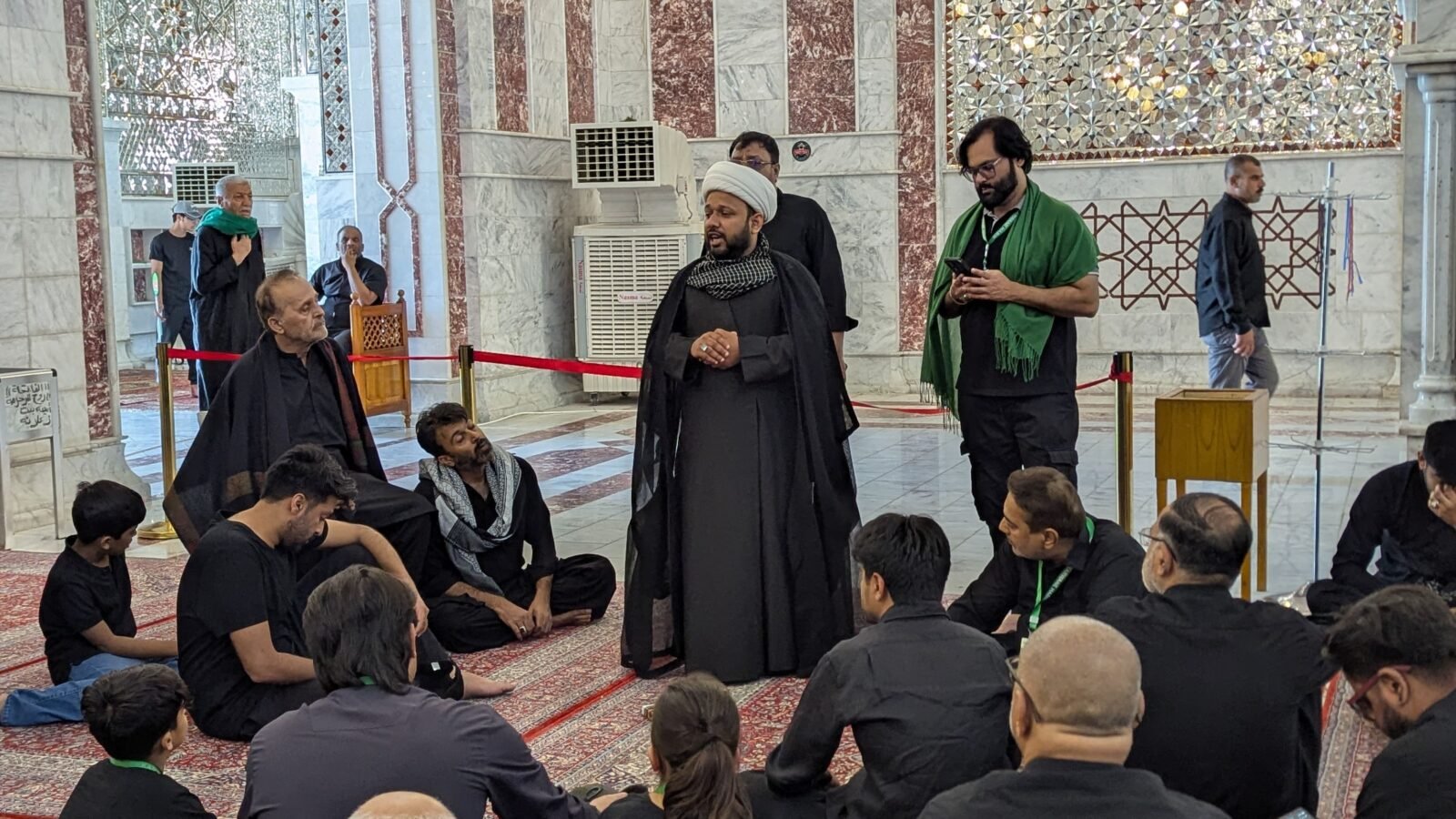 Karwan-e-Habib group seated inside the shrine for ziyarat