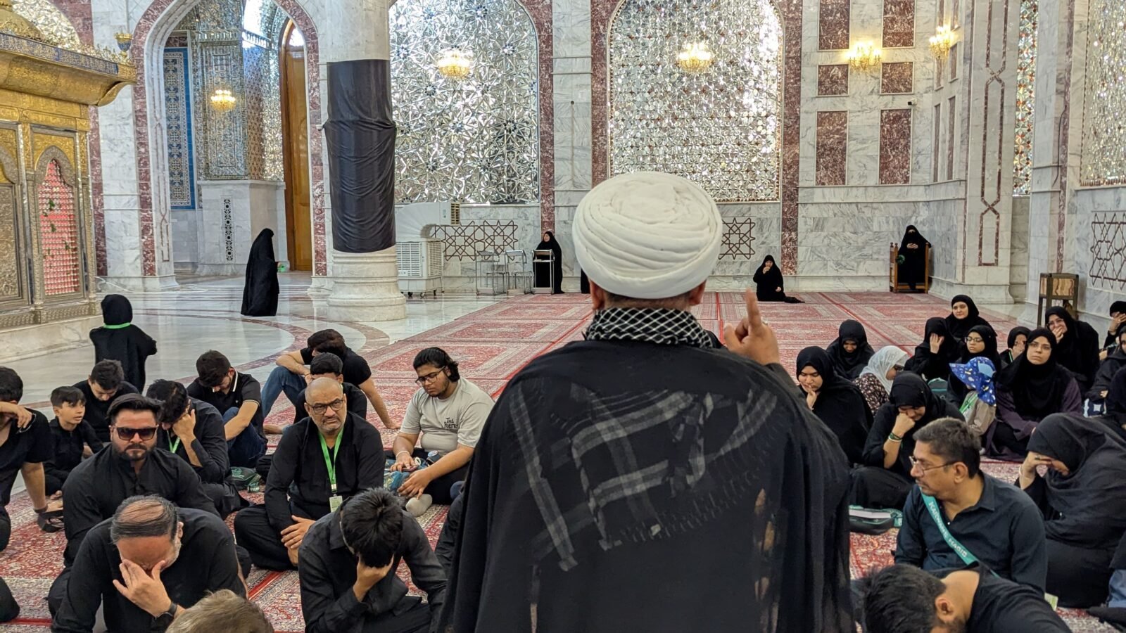 Zaireen seated inside the holy shrine during ziyarat